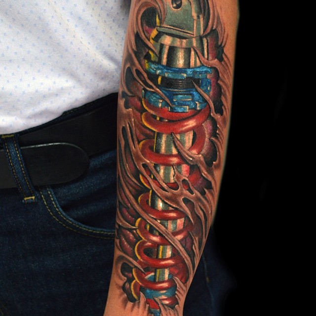 3D Shock Absorber and Biomechanical Leg Tattoo on Arm By FELIPE TORRES at Arkham Tattoo, Bogota, Colombia