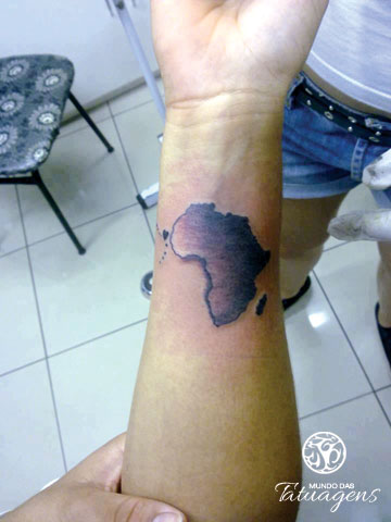 Awful black ink African continent map tattoo on wrist by Mundo das Tatuagens