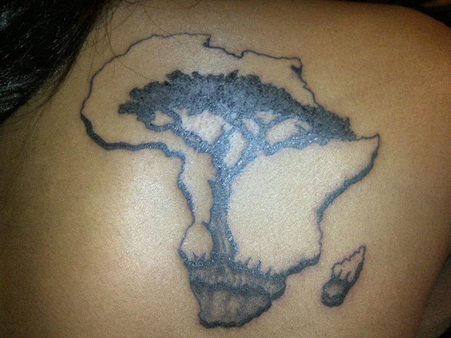 Black Ink Tree In African Map Tattoo On Back
