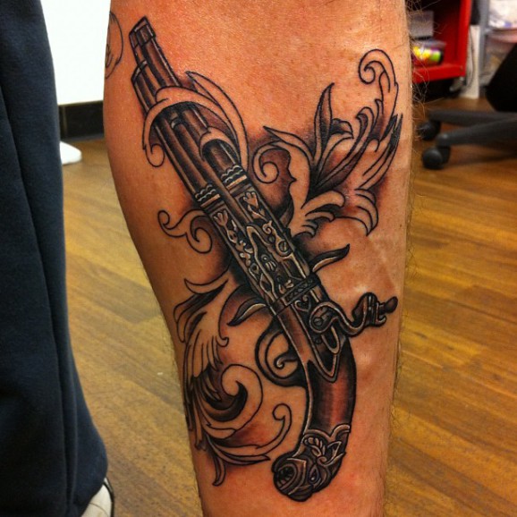 Black and Grey Antique Pistol Tattoo On Forearm