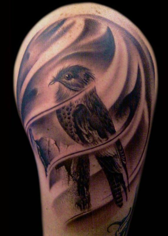 Black and grey Bird tattoo on arm by Francisco Sanchez
