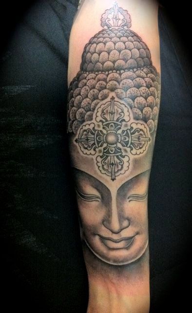 Black inked Buddha face Portrait Tattoo On Arm