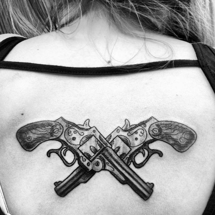 Crossed pistols tattoo on back by Lori McDade