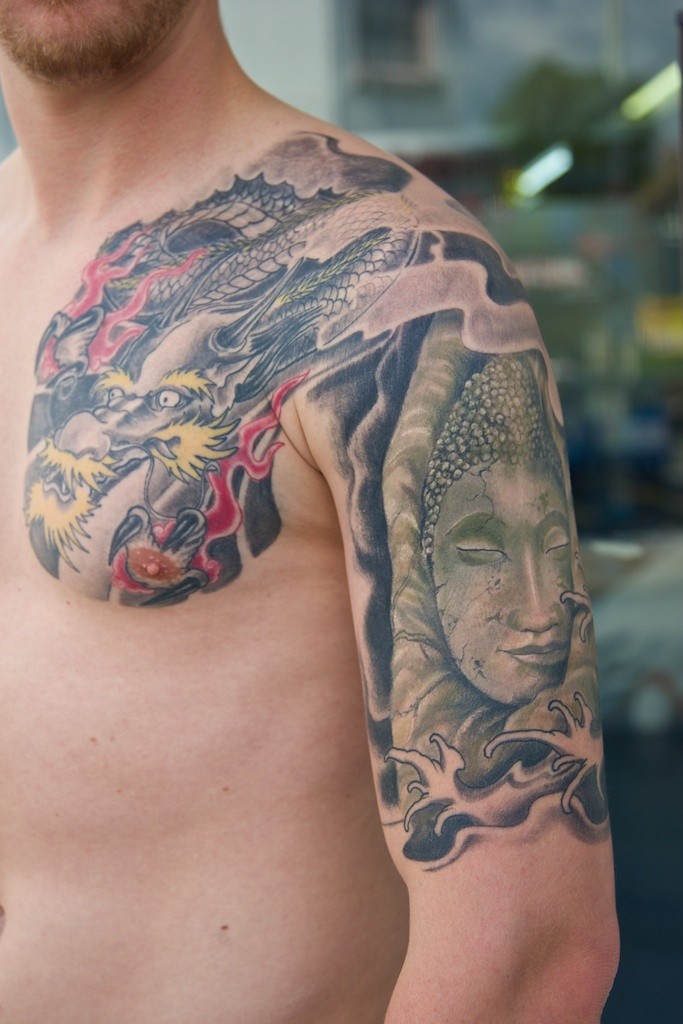 Dragon and Buddha tattoo on arm by Graynd