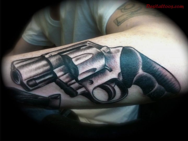 Fantastic grey inked pistol tattoo on forearm