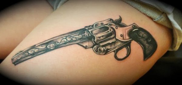 Fantastic old pistol tattoo on thigh