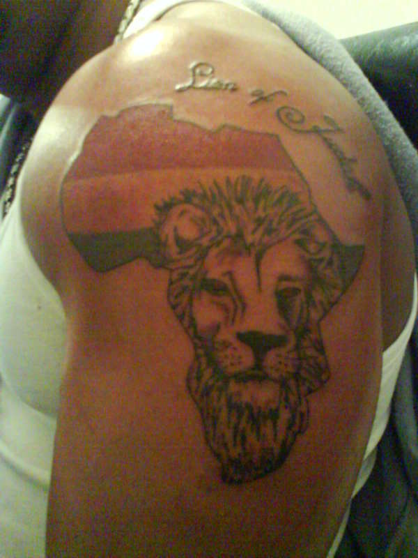 Flag of Ghana colors & lion's face in african continent map with wording Lion of Judah tattoo on shoulder