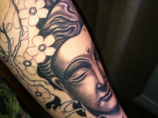 Gautama Buddha tattoo on arm
