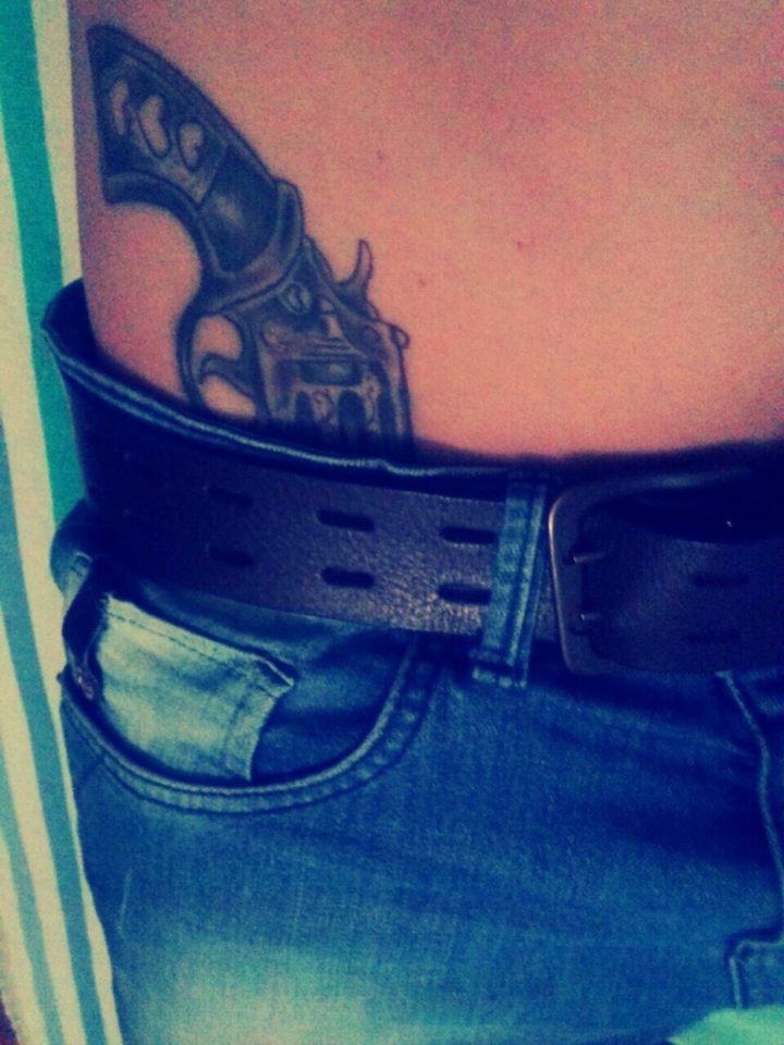Grey Ink Pistol With hearts on handle tattoo On Hip