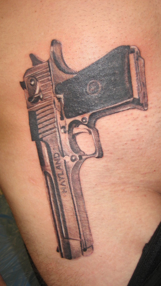 Grey ink Hayland pistol tattoo