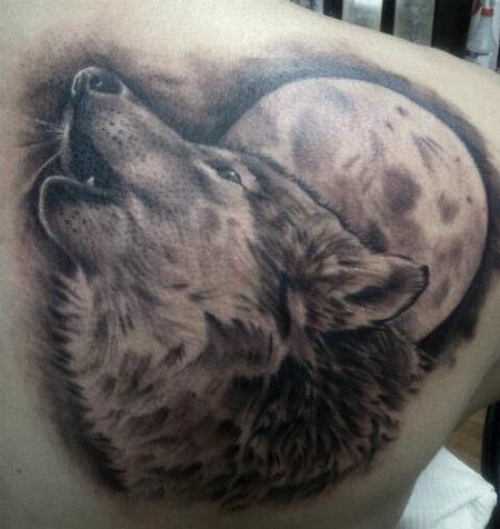 Howling Wolf at full moon tattoo on shoulder back