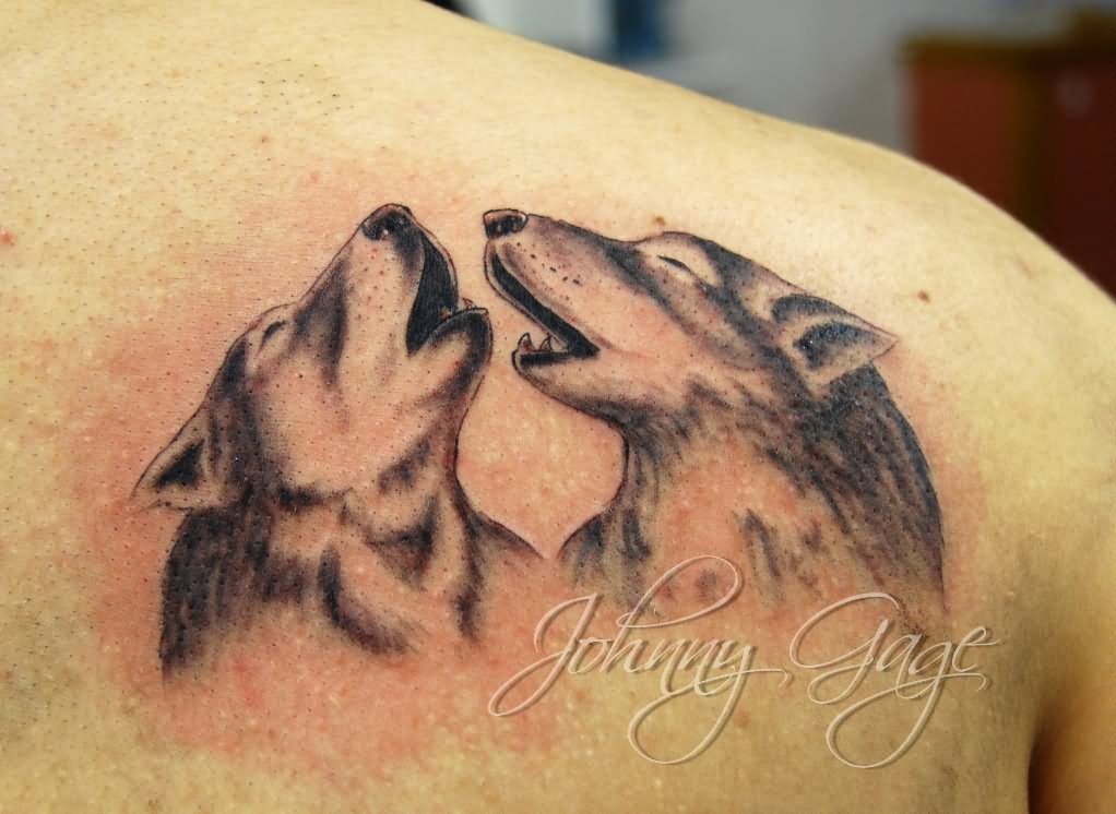 Howling wolf tattoo on back shoulder by Johny Gage at The Tattoo Studio