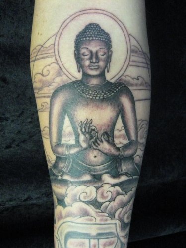 Meditating Buddha statue arm tattoo