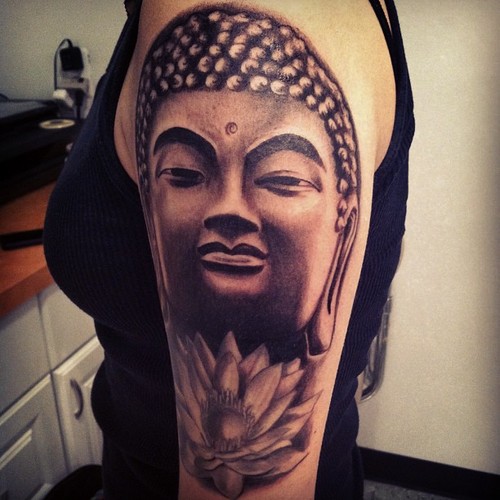 Meditating Buddha with lotus black & white  tattoo on arm