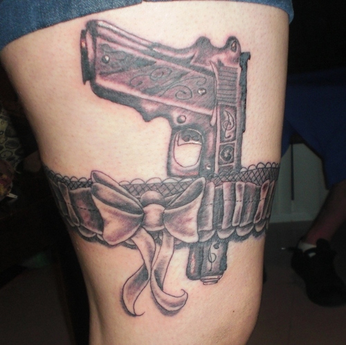 Pistol in bullet holder garter strap tattoo