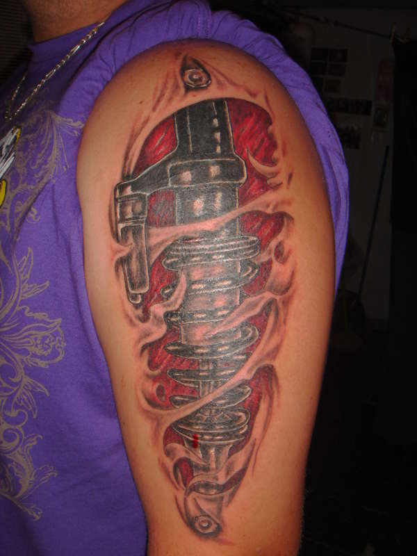 Ripped Skin & Shock Absorber Tattoo On Arm