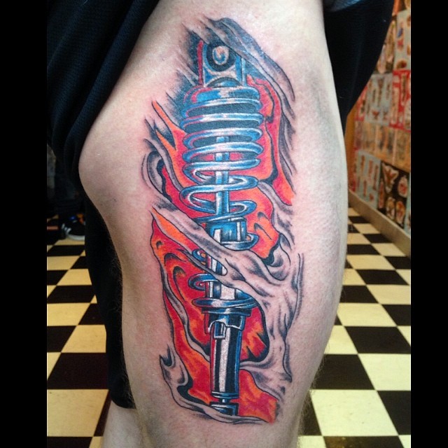 Shock Absorber Coming Out Of Skin Tattoo On Side Rib