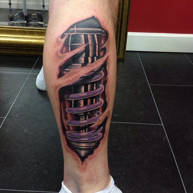Shock absorber tattoo on leg by All Seeing Eye Tattoo Lounge