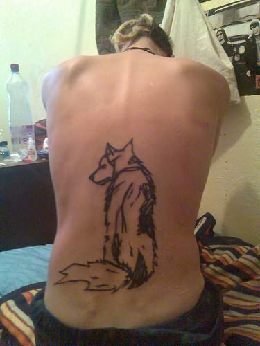 Sitting Wolf's Tattoo On Back