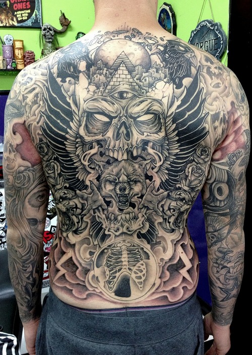 Wolf head and skulls tribal tattoo on full back