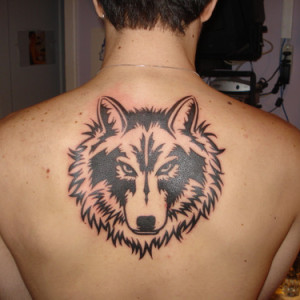 Wolf's Face Tribal Tattoo On Back