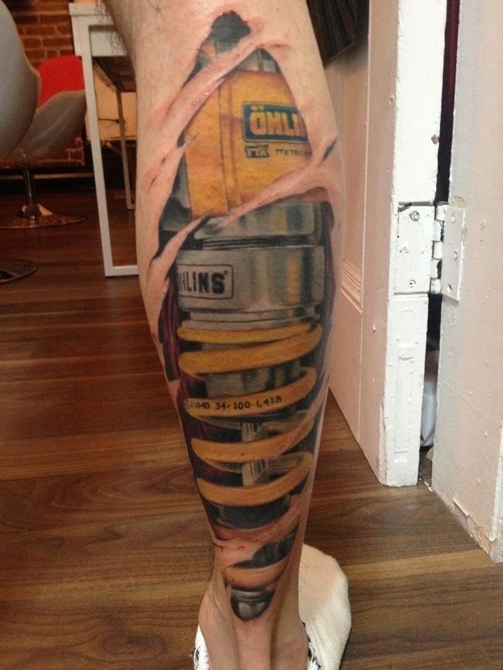 Yellow Shock Absorber Tattoo On Leg (Calf)