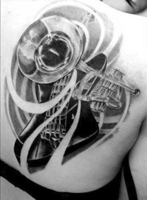 Black and white trumpet and brass guitar tattoo on back