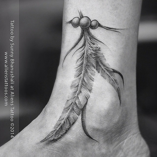 Black & grey feather tattoo on ankle