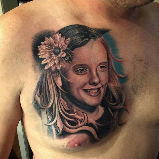 Cute girl’s portrait tattoo on chest