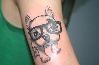 Cute puppy wearing glasses tattoo on arm