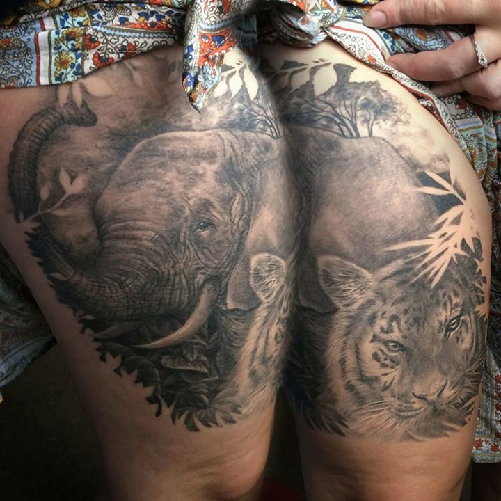 Elephant and tiger - wildlife tattoo on thighs by Samm Lacey