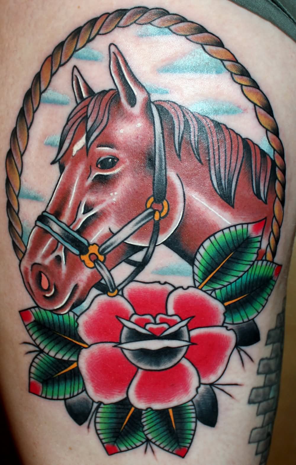 Horse with rope border tattoo on thigh