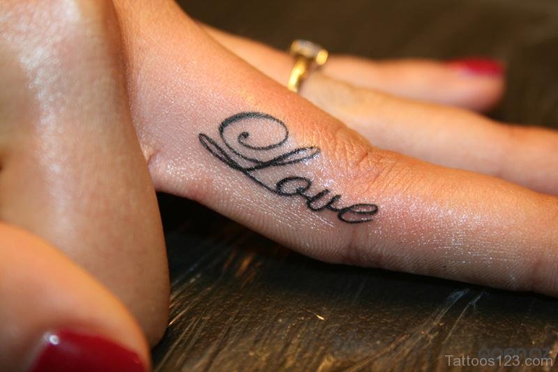 Love word tattoo on middle finger