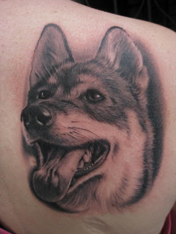 Open mouthed dog portrait tattoo on back shoulder