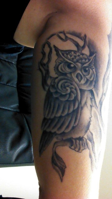 Owl tattoo on bicep by Corey Miller