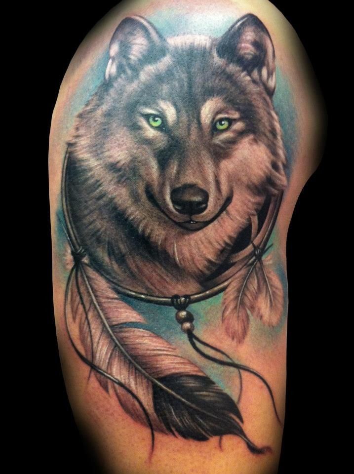 Realistic wolf and feather tattoo