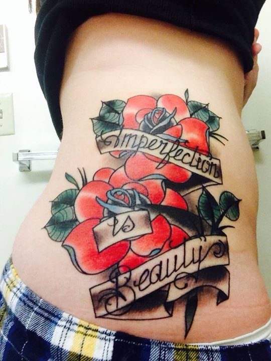 Rose Flowers And Imperfection Is Beauty Banner Tattoo On Rib Cage