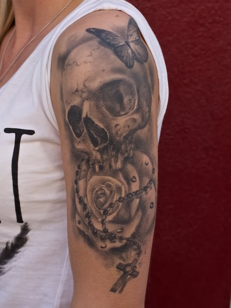 Skull with rose & cross tattoo on sleeve