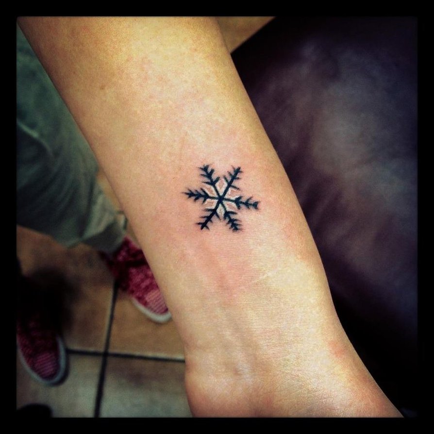 Tiny Snowflake tattoo on forearm