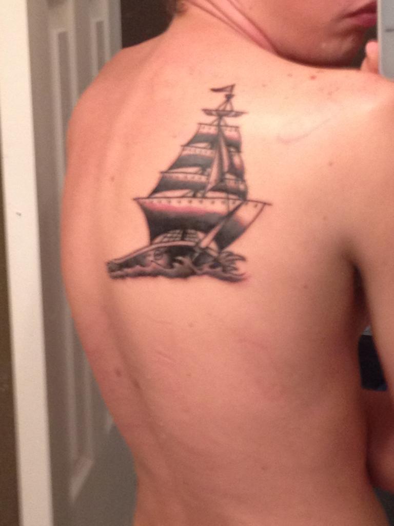 Black And Grey Sailboat Tattoo On Right Back Shoulder
