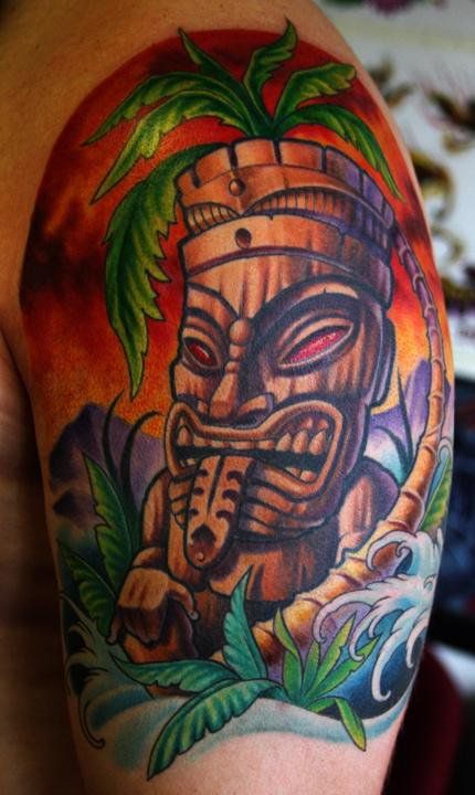 Colorful Tiki Tattoo On Left Half Sleeve by Cory Norris