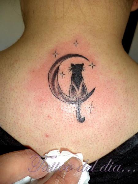 Crescent moon cat tattoo on upperback