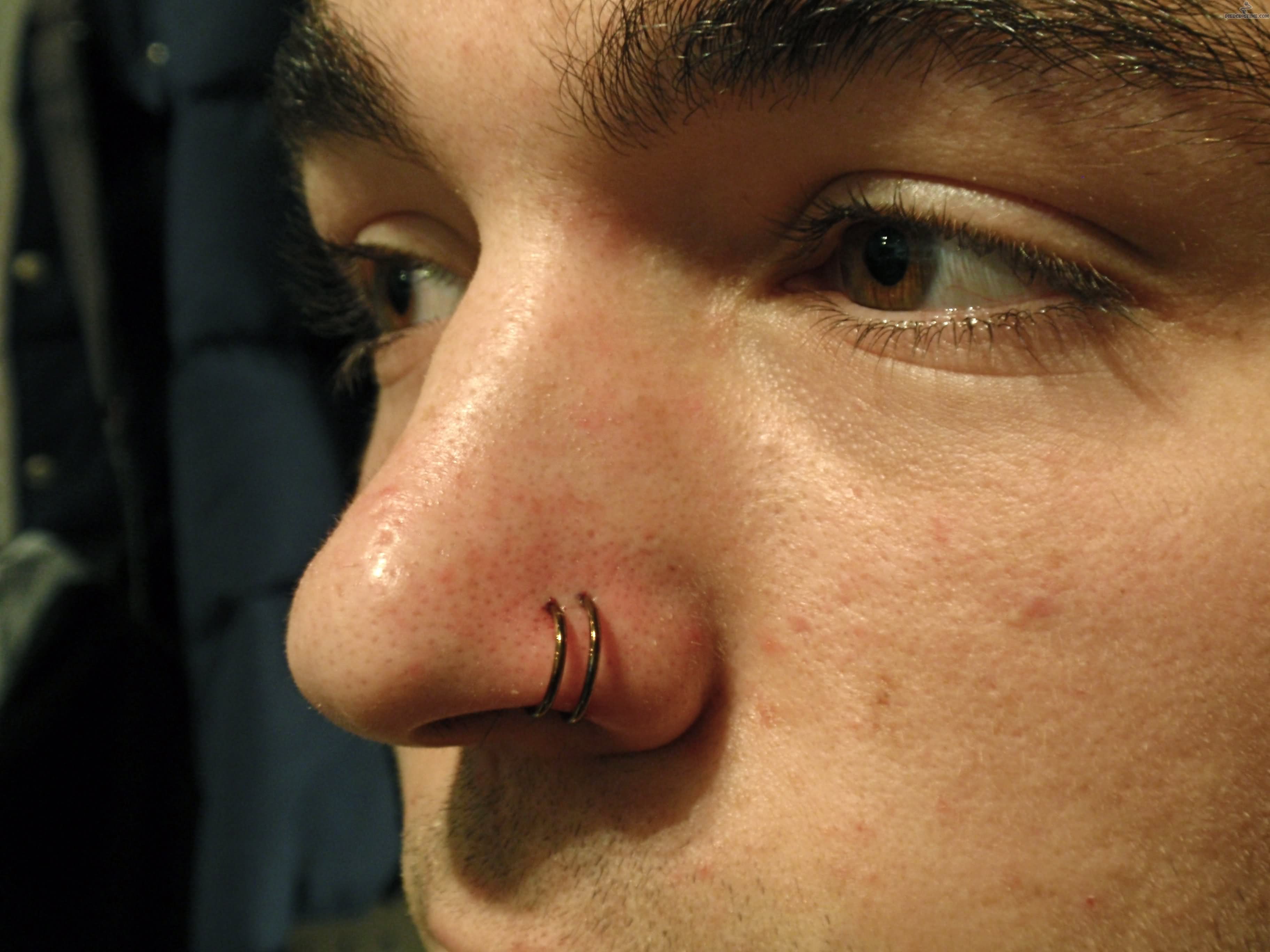 Double Nose Piercing With Hoop Rings.