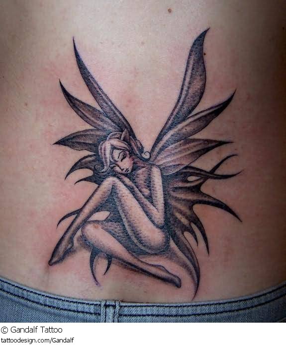 Grey Tribal Fairy Tattoo On Lower Back by Gandalf Tattoos