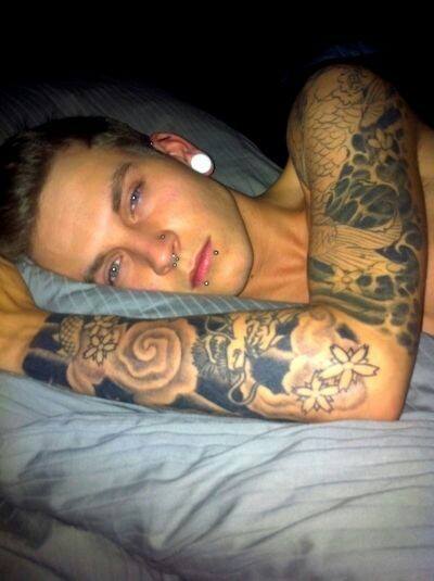 Guy With Sleeve Tattoo And Multiple Face And Ear Piercings
