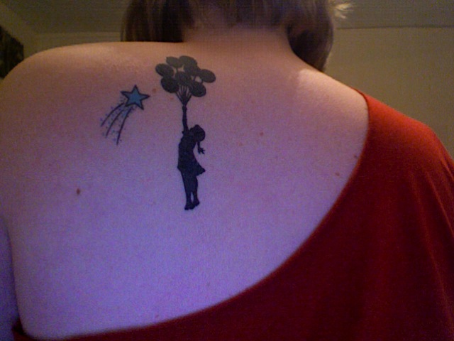 Shooting Star And Banksy Girl Tattoo On Back Shoulder