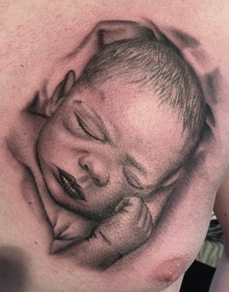 Sleeping Baby Tattoo On Man Chest by Herm