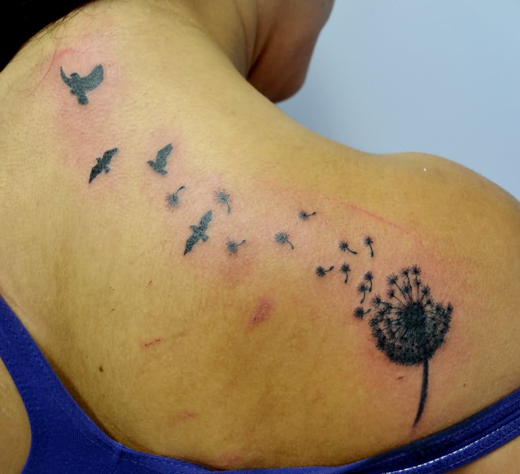 Birds flying out dandelion tattoo on back shoulder