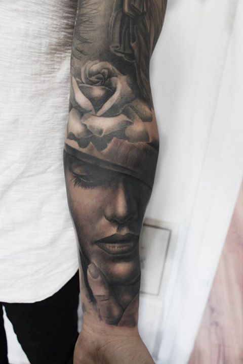 Black and grey portrait tattoo on full sleeve
