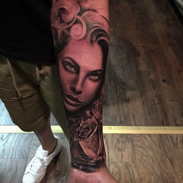 Black ink girl's portrait tattoo with rose on forearm by Rember orellana.